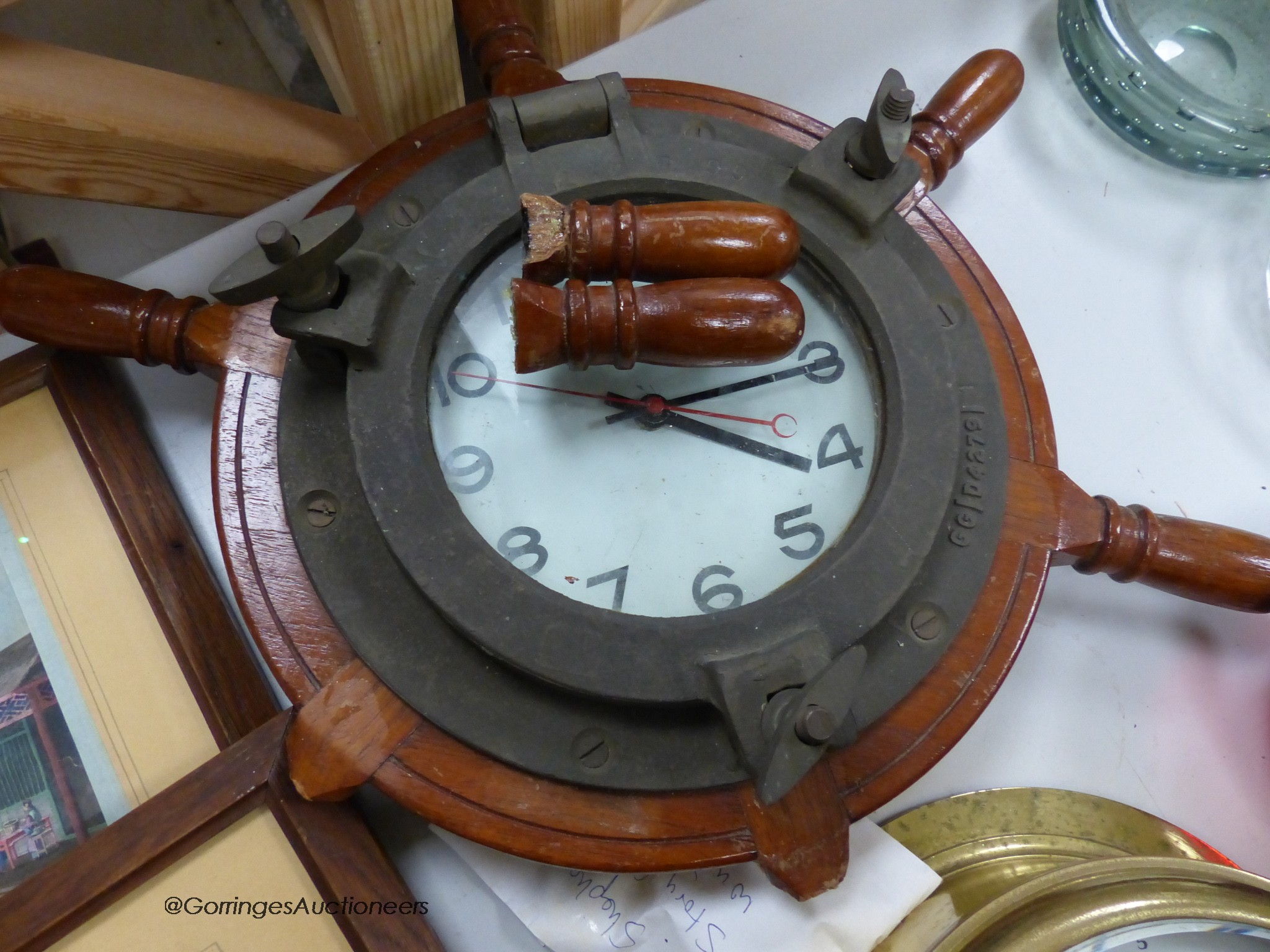 A brass bulkhead timepiece, enamelled dial signed Story, Barrow, dial 17cm, and a ship's wheel wall timepiece by Bayard